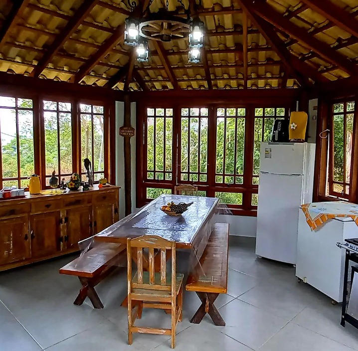 Cozinha compartilhada do Recanto Feliz com mesa e bancos de madeira